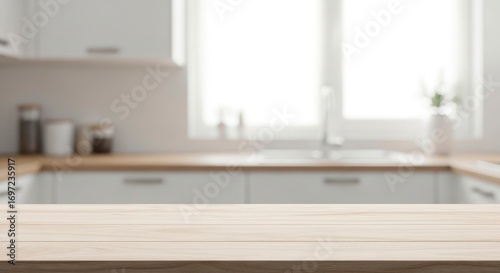 A blurry kitchen scene with white cabinets a wooden counter and a bright window