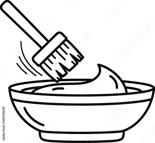 brush dips into a bowl of creamy substance, symbolizing mixing or preparation.