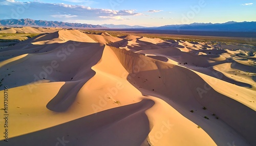 Fototapeta Naklejka Na Ścianę i Meble -  Aerial View of Beige Sand Dunes with Shadows at Sunset
