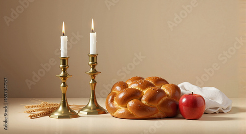 Challah bread, apple, and candles for festive meal on table  