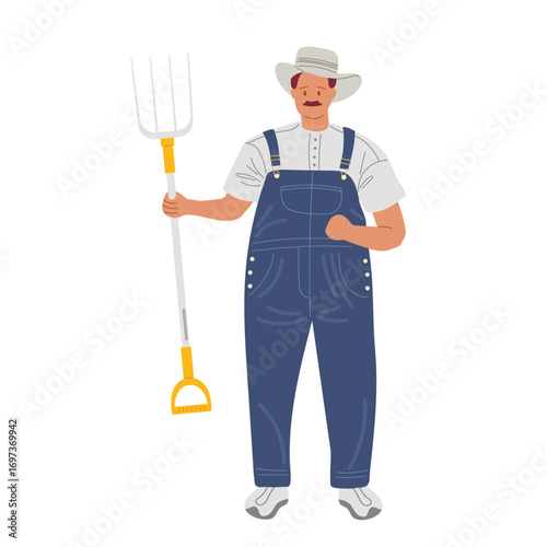 Farmer holding a pitchfork in overalls with a straw hat on a sunny day