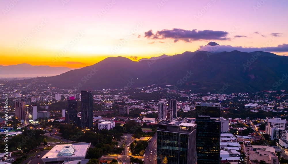 Obraz premium City skyline at sunset with mountains in the background