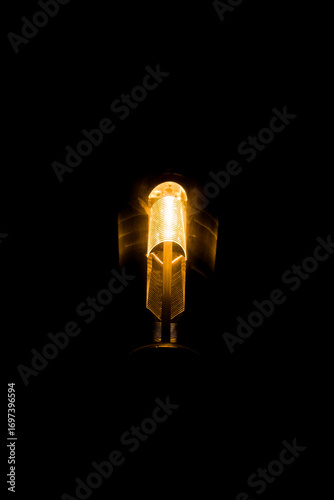Glowing Spiral Filament Light Bulb on Black
