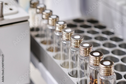 Laboratory glass vials containing samples awaiting analysis in a medical research lab