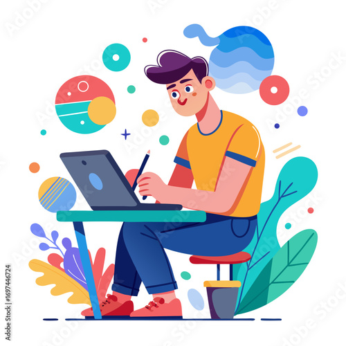 A young man works on a laptop at a desk surrounded by colorful shapes