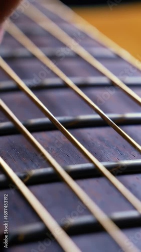 footage vertical video, close-up of guitar strings vibrating