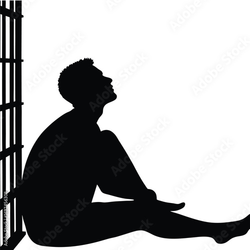 Silhouette of a man sitting by prison bars looking up Keywords: silhouette, man, prison, bars