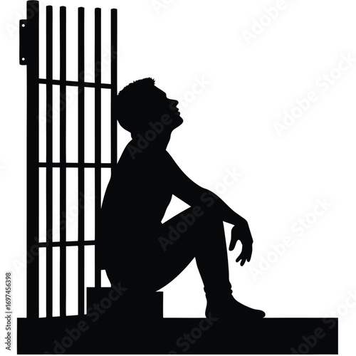 Silhouette of a man sitting on steps by prison bars looking up Keywords: silhouette, man, prison