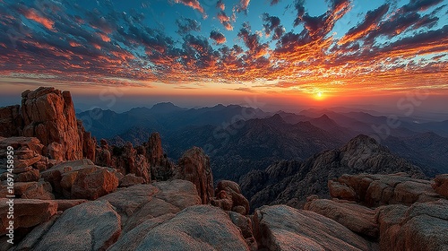 Rocky mountain landscape with colorful sunset sky.