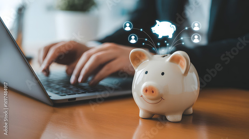 Financial Growth: A digital piggy bank symbolizes the future of finance, sitting beside a laptop as hands type on the keyboard. This image tells a story of planning, saving.
