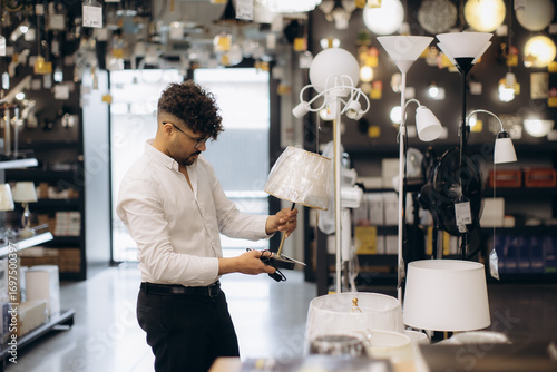 Man Shopping for Table Lamps in a Home Lighting Store