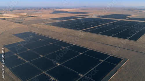 Aerial view of a large solar farm in Santa Margarita, California, USA. The panels are arranged in rows and columns, generating clean, renewable energy from the sun.