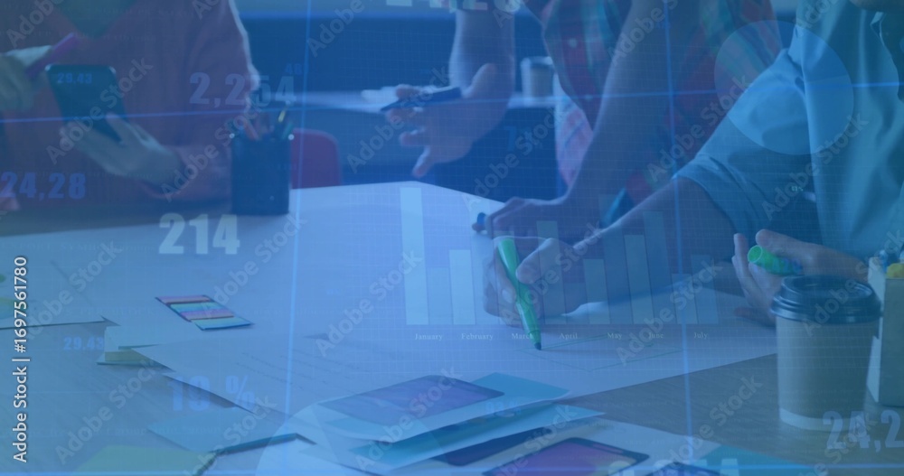 Naklejka premium Collaborating team members annotating app mockups in meeting room, with smartphone highlighters