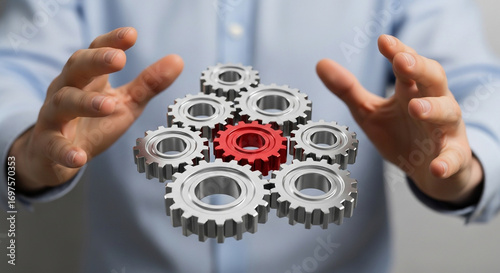 Businessman's hands orchestrate a dynamic system of interconnected gears symbolizing teamwork and innovation