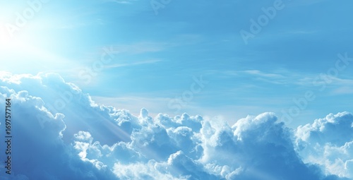 Ethereal skyscape featuring fluffy clouds and brilliant sunlight, bathed in soft hues of blue, creating a serene, heavenly atmosphere
