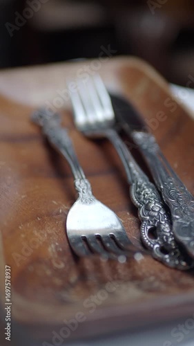 Unique silverware displayed on a wooden tray