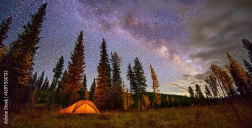 Glowing tent nestled in a forest clearing under a vast, star-studded night sky with a visible Milky Way arching overhead