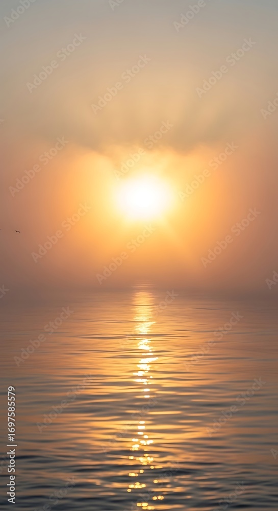 Fototapeta premium Serene sunrise paints the sky in warm hues, casting a golden path across tranquil ocean waters with gentle waves and distant birds soaring peacefully.