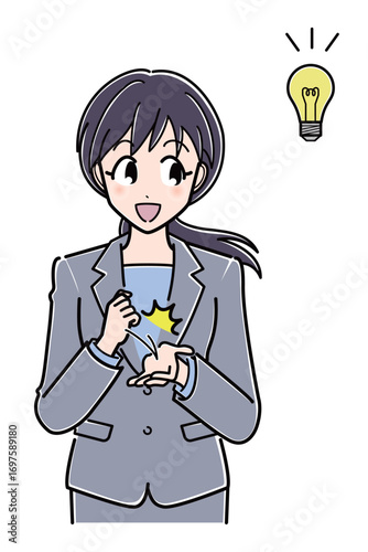 ひらめいて手を打つスーツのOLさん（上半身）