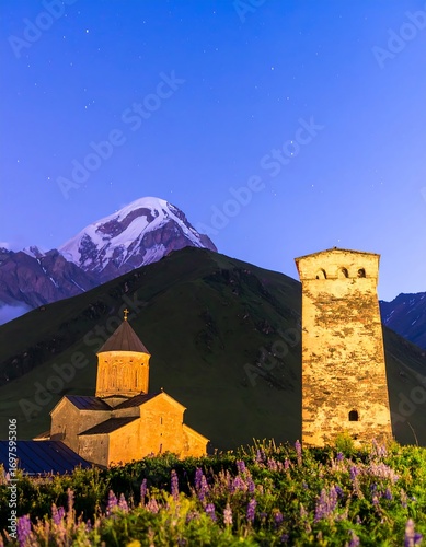 Mountain village at dawn with church and tower