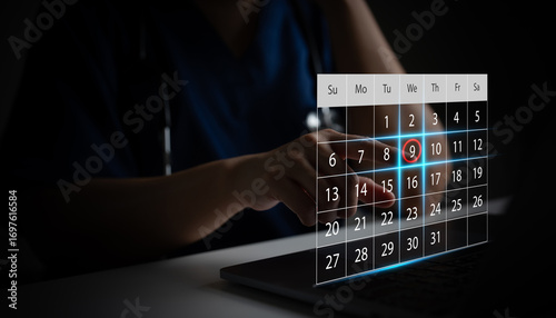 Doctor selecting appointment date on digital calendar using laptop. Concept of healthcare scheduling, hospital booking system and online medical appointment reminder. Doctor appointment with patient.