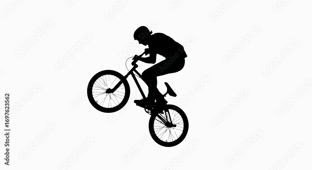 Fototapeta premium A silhouette of a bike rider doing stunts depicts freedom and daring challenges on two wheels
