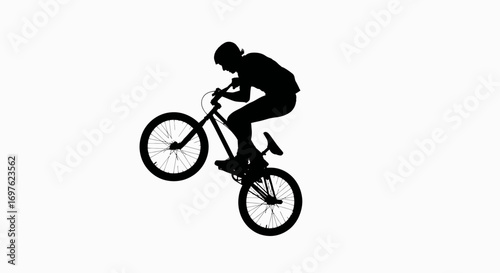A silhouette of a bike rider doing stunts depicts freedom and daring challenges on two wheels