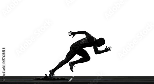 Silhouette of determined athlete launching from starting blocks in track event