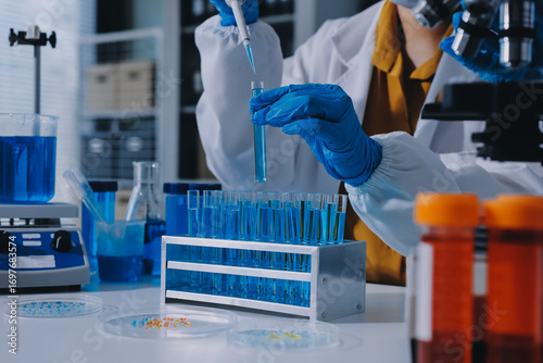 Collaboration, tablet or science with people in lab together for research or development. Innovation, tech and microscope with scientist team in clinical trial for planning or medical investigation