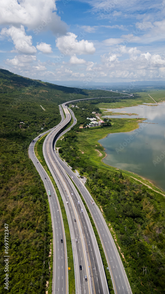 Fototapeta premium Drone shot The M6 motorway Nakhon Ratchasima Province - Bang Pa-in Lam Ta Khong River and Mountain. Motorway Korat Thailand