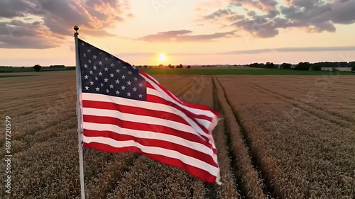 American Flag Waving in Golden Wheat Field at Sunset Dramatic Sky