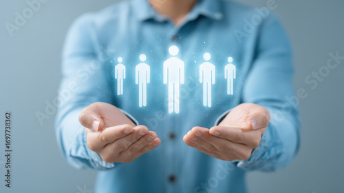 Human resources concept with hands holding holographic team icons, representing leadership and workforce management