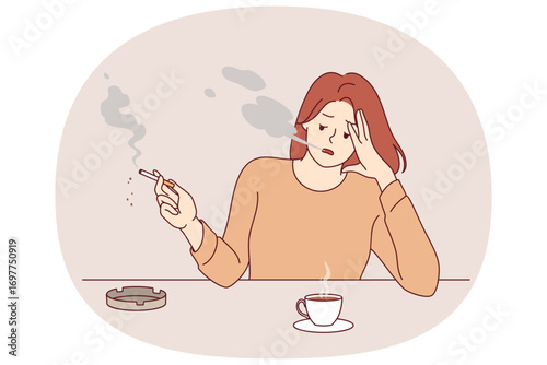 Woman smokes cigarette and drinks hot coffee from cup, sitting at table taking break after difficult work. Stressed girl suffering from tobacco addiction and habit of caffeine for energy.