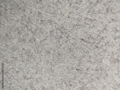 A macro close-up revealing the textured, porous fibers of a heat transfer paper's backing. The abstract, messy texture with visible imperfections is ideal for backgrounds or artistic projects.