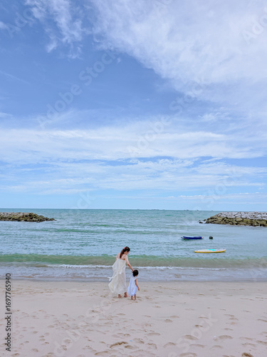 Kid on the beach. vacation of girl with mommy happy at the sea shore