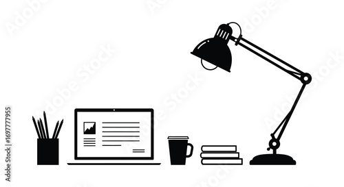 a cozy workspace setup with desk lamp laptop books and mug