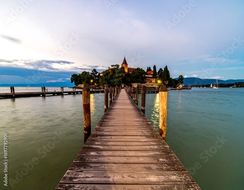 Lakeside pier leads to an island at sunset
