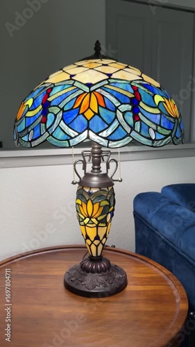 Blue table stained glass lamp on the wooden table next to blue sofa