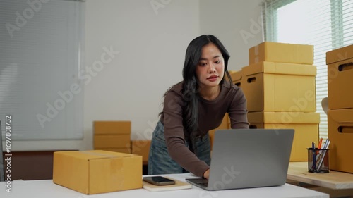 Asian woman managing sme business, preparing packages
