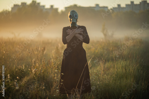 Obraz na plátne Creepy mysterious character wearing mask and gasmask in fog