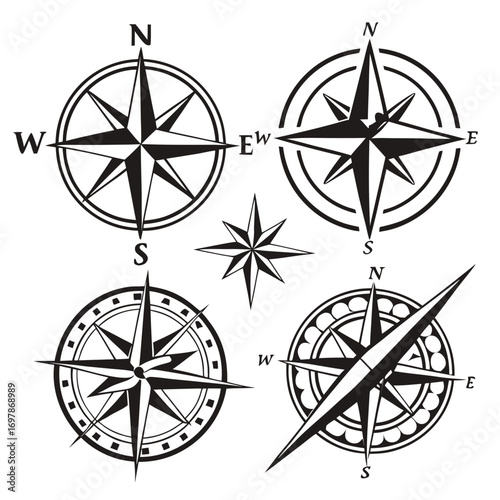Collection of stylized black and white compass rose designs with cardinal directions and decorative elements