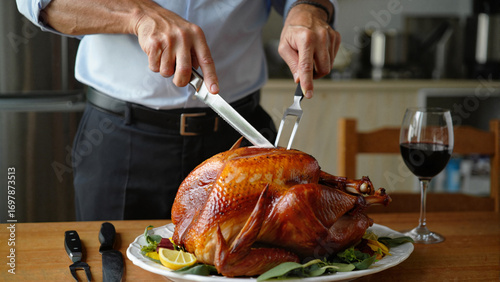 Man carving roast turkey in kitchen