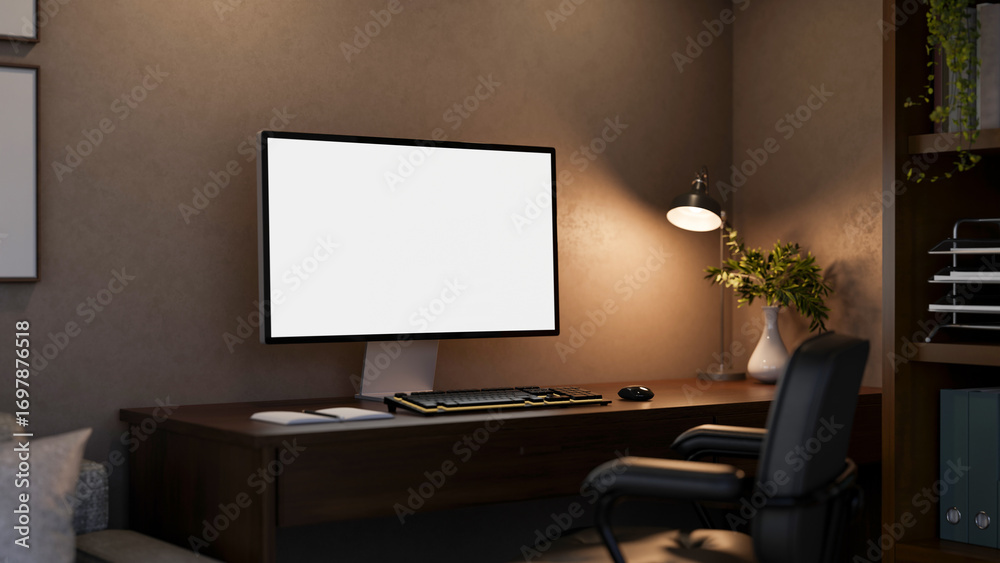 Blank screen computer under lamp light on wooden table with leather swivel chair in a dim lit room.