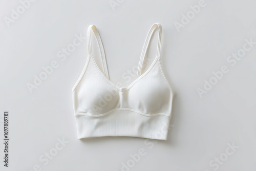 Simple and elegant white ribbed sports bra on white background for yoga, pilates, or athleisure, comfortable everyday wear.