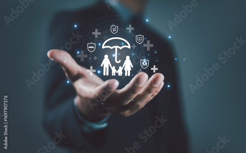 Billede på lærred Businessman holding digital family insurance icon with umbrella, symbolizing health protection, life insurance, financial security, risk management, and family care solutions for modern safety