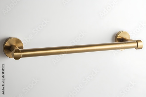 Gold-tone metal grab bar mounted on a white wall. Minimalist design with round bases