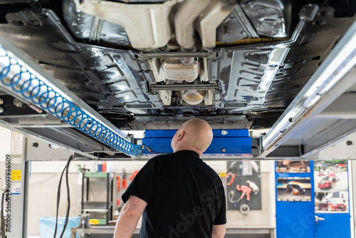 An Auto Technician Thoroughly Inspects the Vehicles Undercarriage for Necessary Repairs