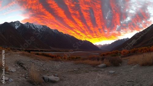 Fiery Sunset Paints Mountain Valley with Vibrant Hues