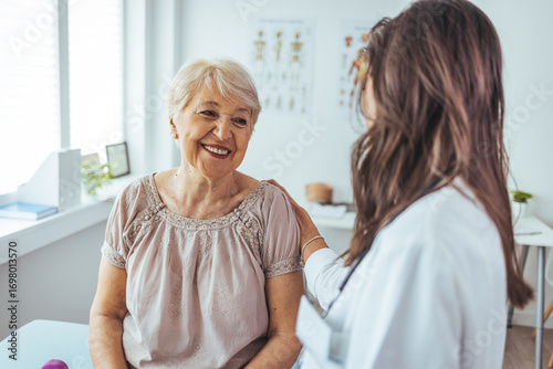 Wallpaper Mural Elderly Woman Smiling During Consultation with Caring Female Doctor at Clinic Torontodigital.ca