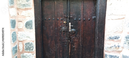 Antique handle of a solid wood door in Tuscan style.
